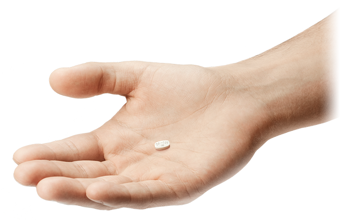 Hand holding ABILIFY MYCITE® (aripiprazole tablets with sensor) tablet